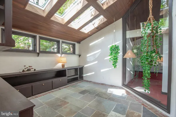 a dining room with furniture and wooden floor