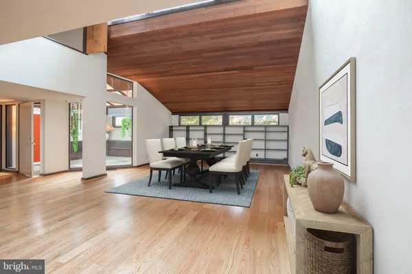 a view of a room with wooden floor and windows
