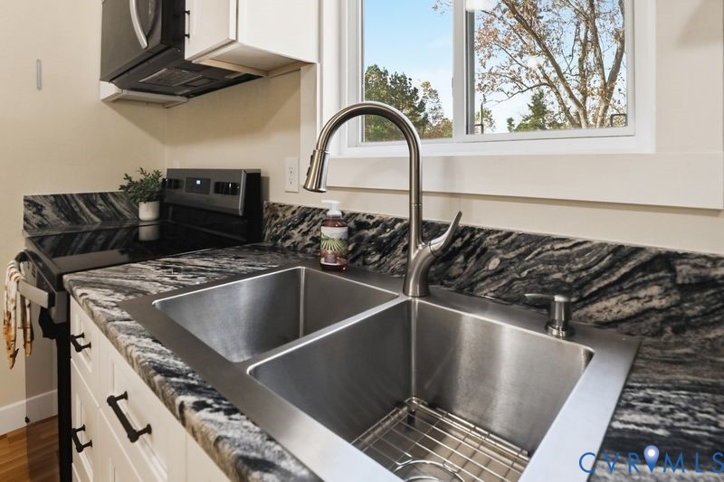 6010 Golden Wheel Road Providence Forge, VA 23140 - Photo 17 of 49 a close view of a stove a sink and dishwasher in a kitchen