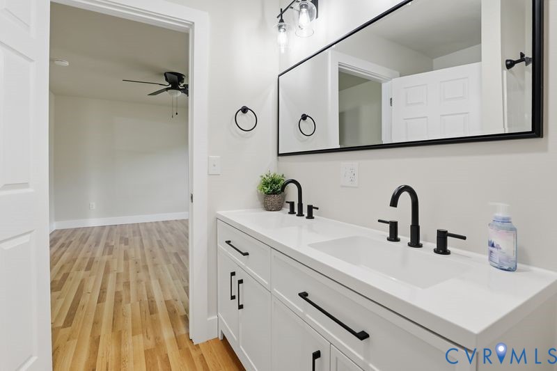 6010 Golden Wheel Road Providence Forge, VA 23140 - Photo 25 of 49 Bathroom with double vanity, light wood-type floor