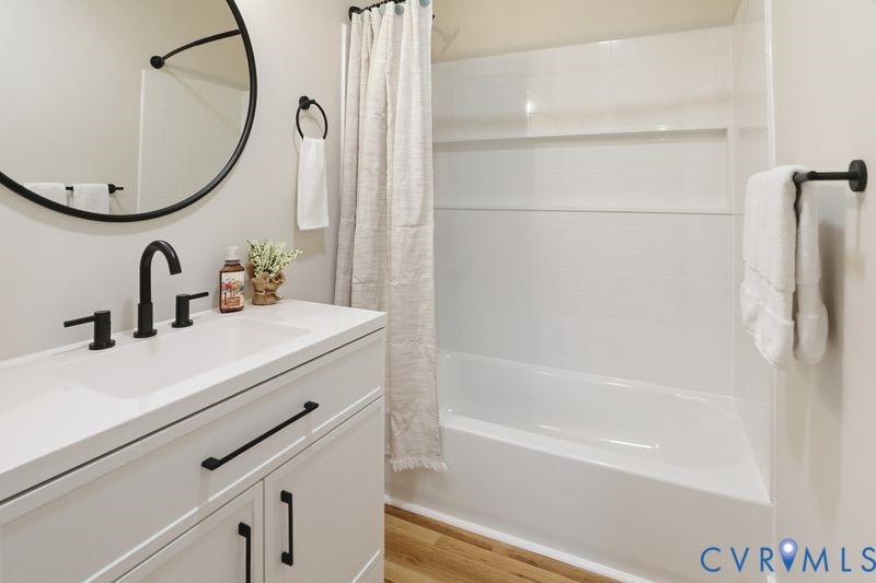 6010 Golden Wheel Road Providence Forge, VA 23140 - Photo 33 of 49 a bathroom with a sink and a mirror with bathtub