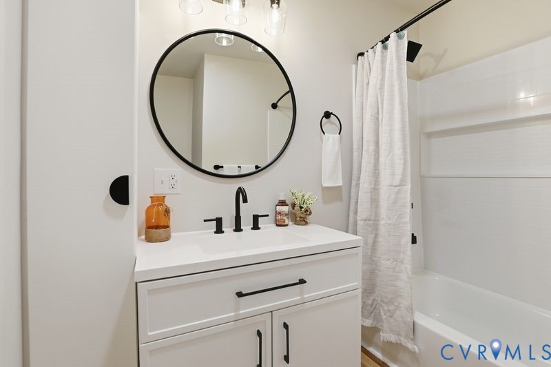 6010 Golden Wheel Road Providence Forge, VA 23140 - Photo 35 of 49 a bathroom with a sink a vanity and a mirror