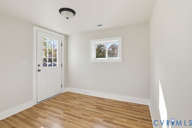 6010 Golden Wheel Road Providence Forge, VA 23140 - Photo 36 of 49 a view of an empty room with wooden floor and a window