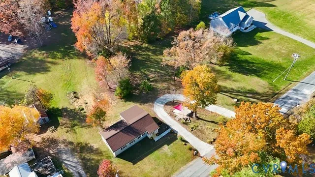 an aerial view of house with yard swimming pool and outdoor seating