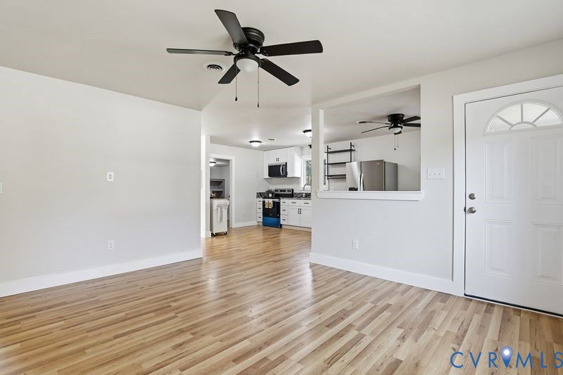 6010 Golden Wheel Road Providence Forge, VA 23140 - Photo 9 of 49 a view of a kitchen with a wooden floor and a ceiling fan