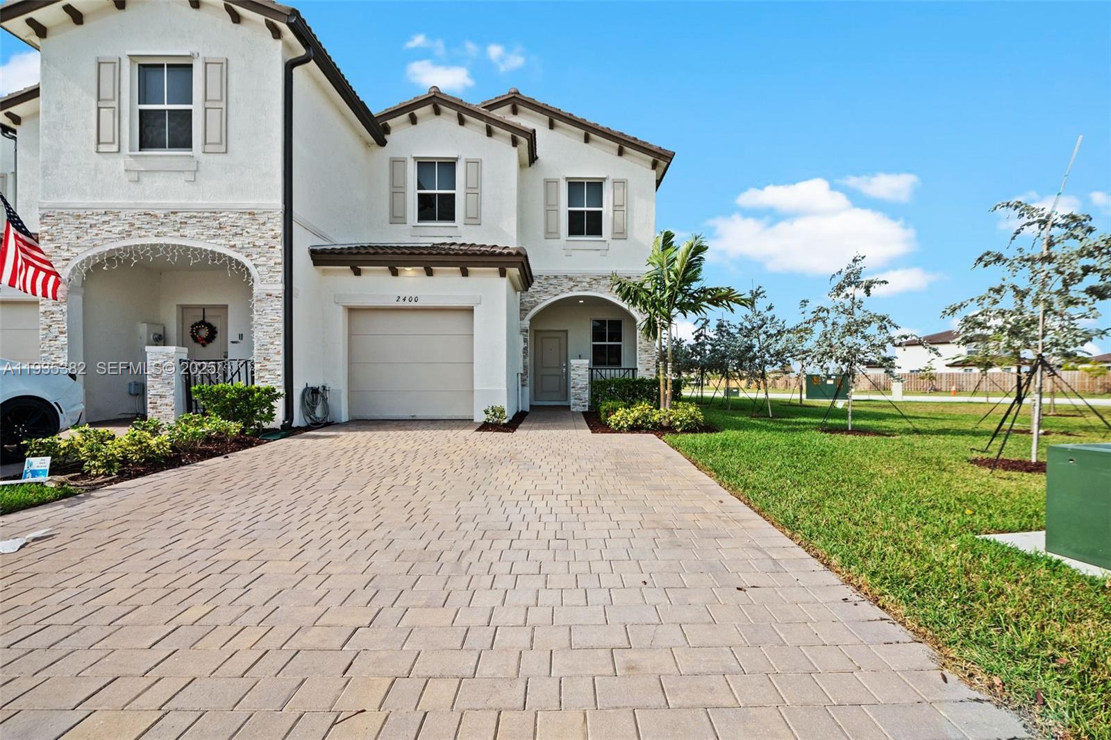 a front view of a house with a garden