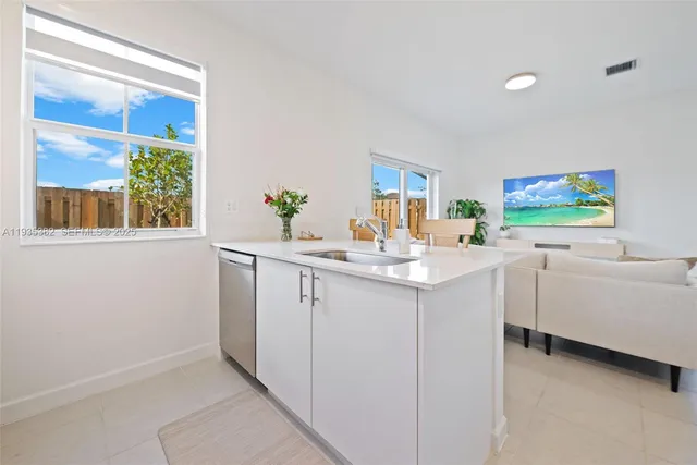 a kitchen with a sink cabinets and window