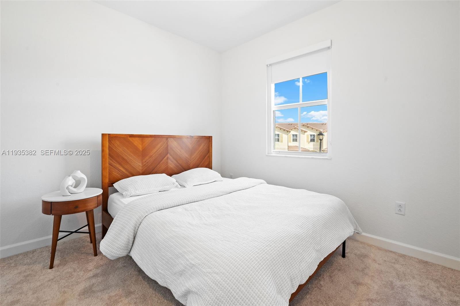 2400 Southeast 29th Street Homestead, FL 33035 - Photo 18 of 25 a bedroom with a bed and a lamp on table