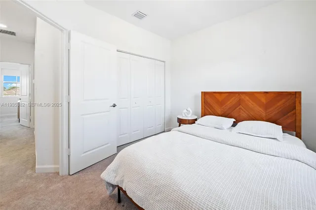 a bathroom with a sink a toilet a mirror and shower curtain