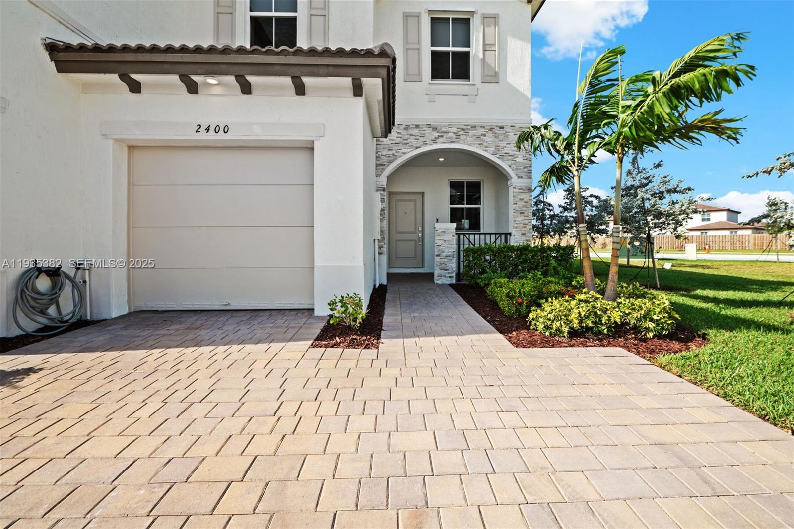 2400 Southeast 29th Street Homestead, FL 33035 - Photo 3 of 25 a front view of a house with a garden