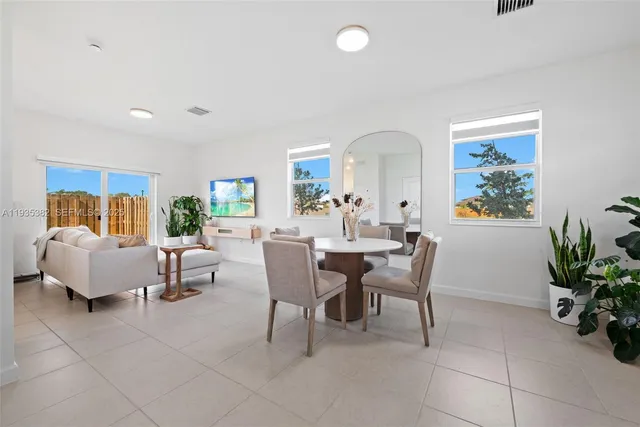 a dining room with furniture and wooden floor