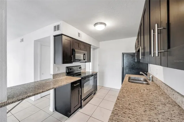 a kitchen with granite countertop a sink and a granite counter tops