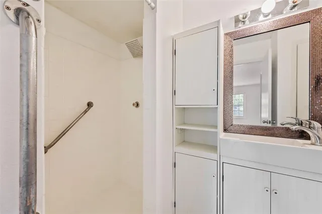 a bathroom with a mirror and a shower