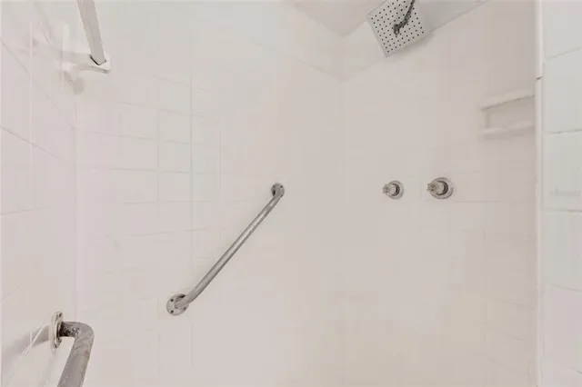 a front view of a house with plants and wooden fence