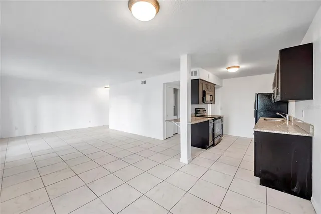 a kitchen with stainless steel appliances a refrigerator and a stove top oven