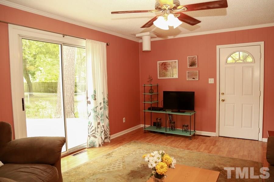 1501 Kelly Road Garner, NC 27529 - Photo 12 of 25 a living room with furniture and a flat screen tv