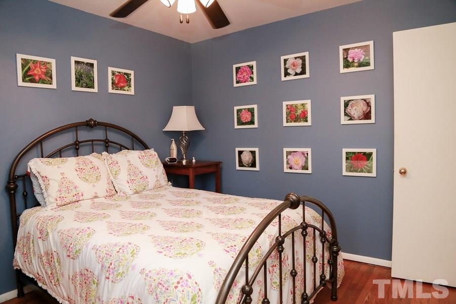 1501 Kelly Road Garner, NC 27529 - Photo 15 of 25 a bedroom with a bed and a lamp on table