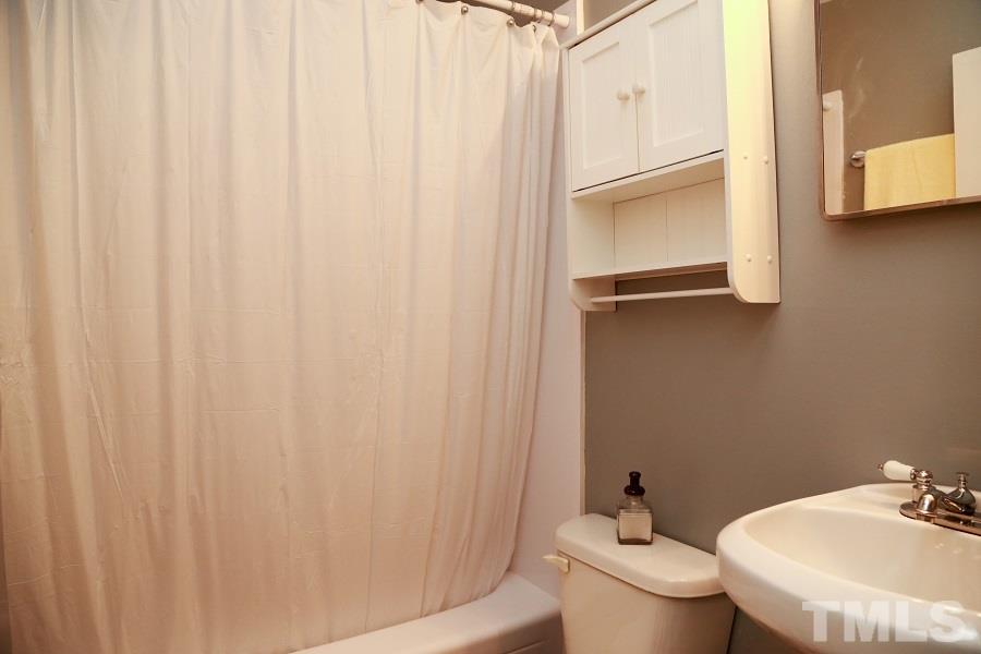 1501 Kelly Road Garner, NC 27529 - Photo 20 of 25 a bathroom with a granite countertop sink and a toilet