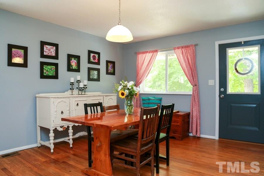 1501 Kelly Road Garner, NC 27529 - Photo 3 of 25 a view of a dining room with furniture window and wooden floor