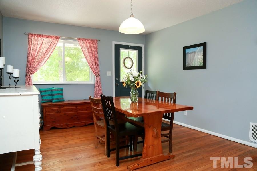 1501 Kelly Road Garner, NC 27529 - Photo 5 of 25 a view of a dining room with furniture window and wooden floor