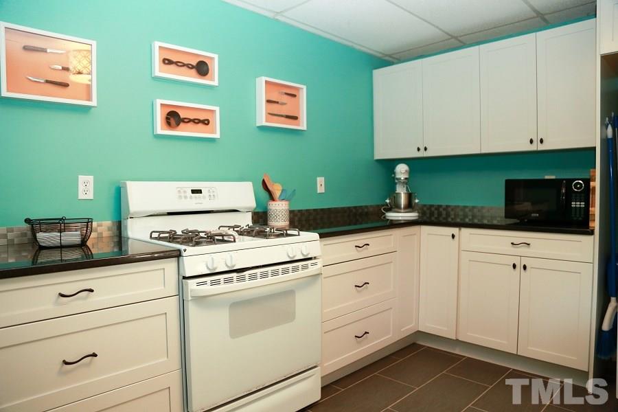 1501 Kelly Road Garner, NC 27529 - Photo 8 of 25 a kitchen with white cabinets and white appliances