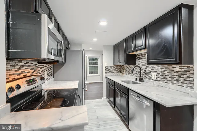 a kitchen with a sink stove and cabinets