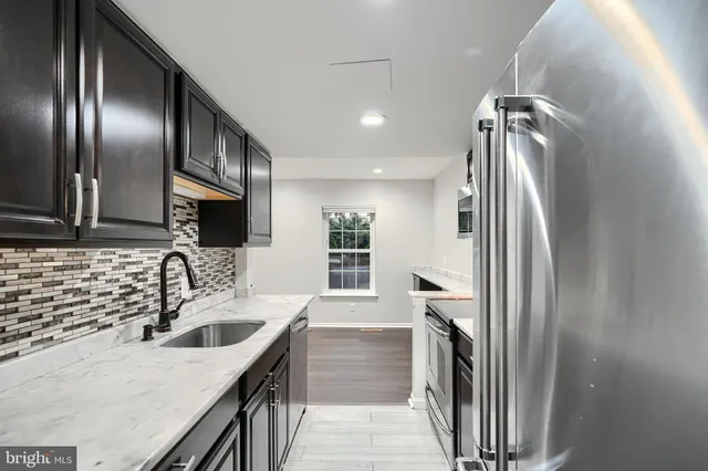 a kitchen with a sink stove and refrigerator