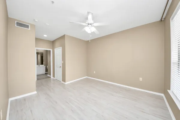 a bedroom with a bed furniture and a chandelier
