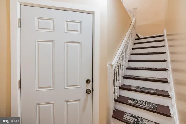 a view of a hallway with wooden floor and entryway