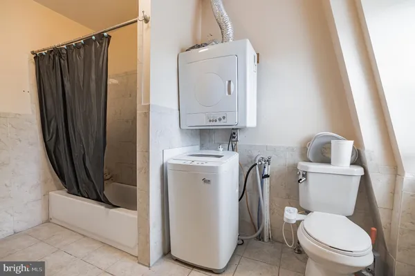 a white toilet sitting next to a bathroom sink