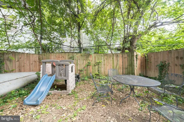 a backyard of a house with table and chairs