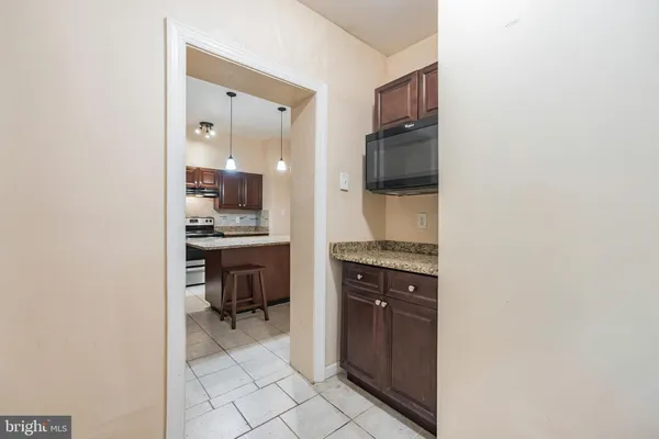 a kitchen with a refrigerator and a stove top oven