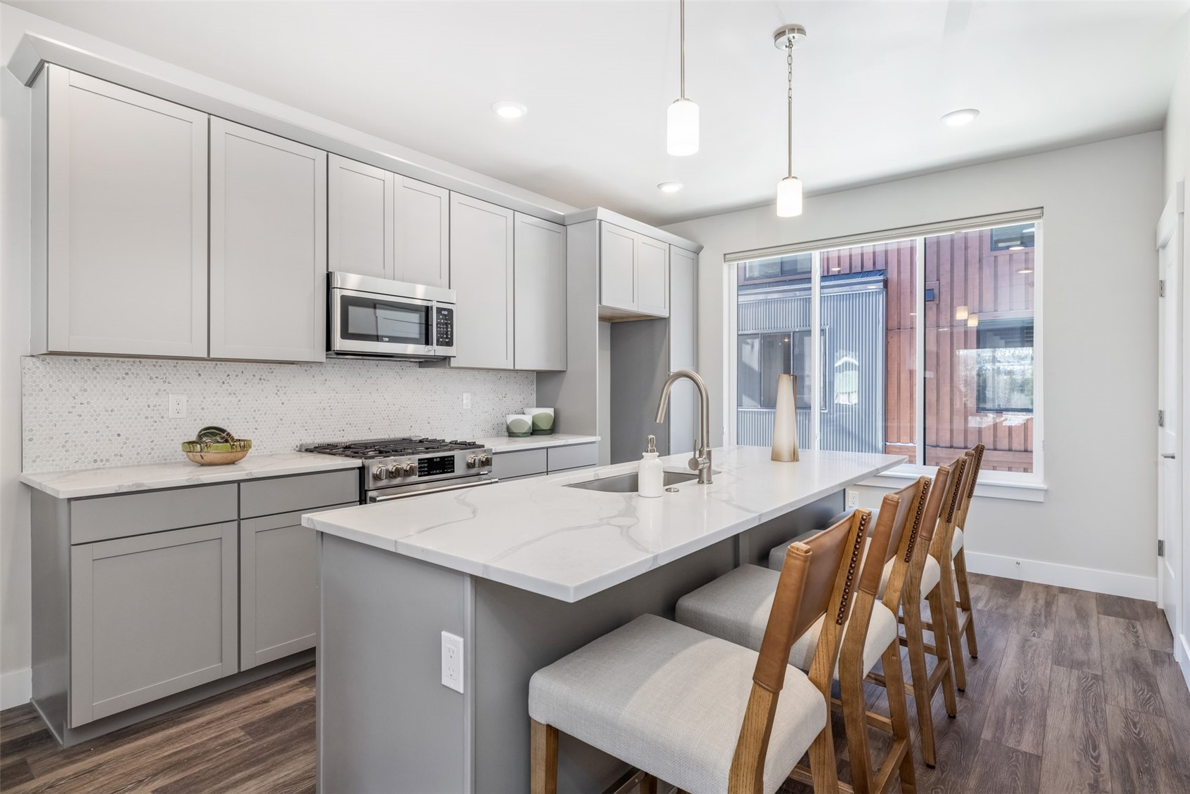 1301 Adams Avenue, Unit 128 Silverthorne, CO 80498 - Photo 5 of 27 a kitchen with stainless steel appliances granite countertop a stove a sink a microwave a refrigerator and white cabinets with wooden floor