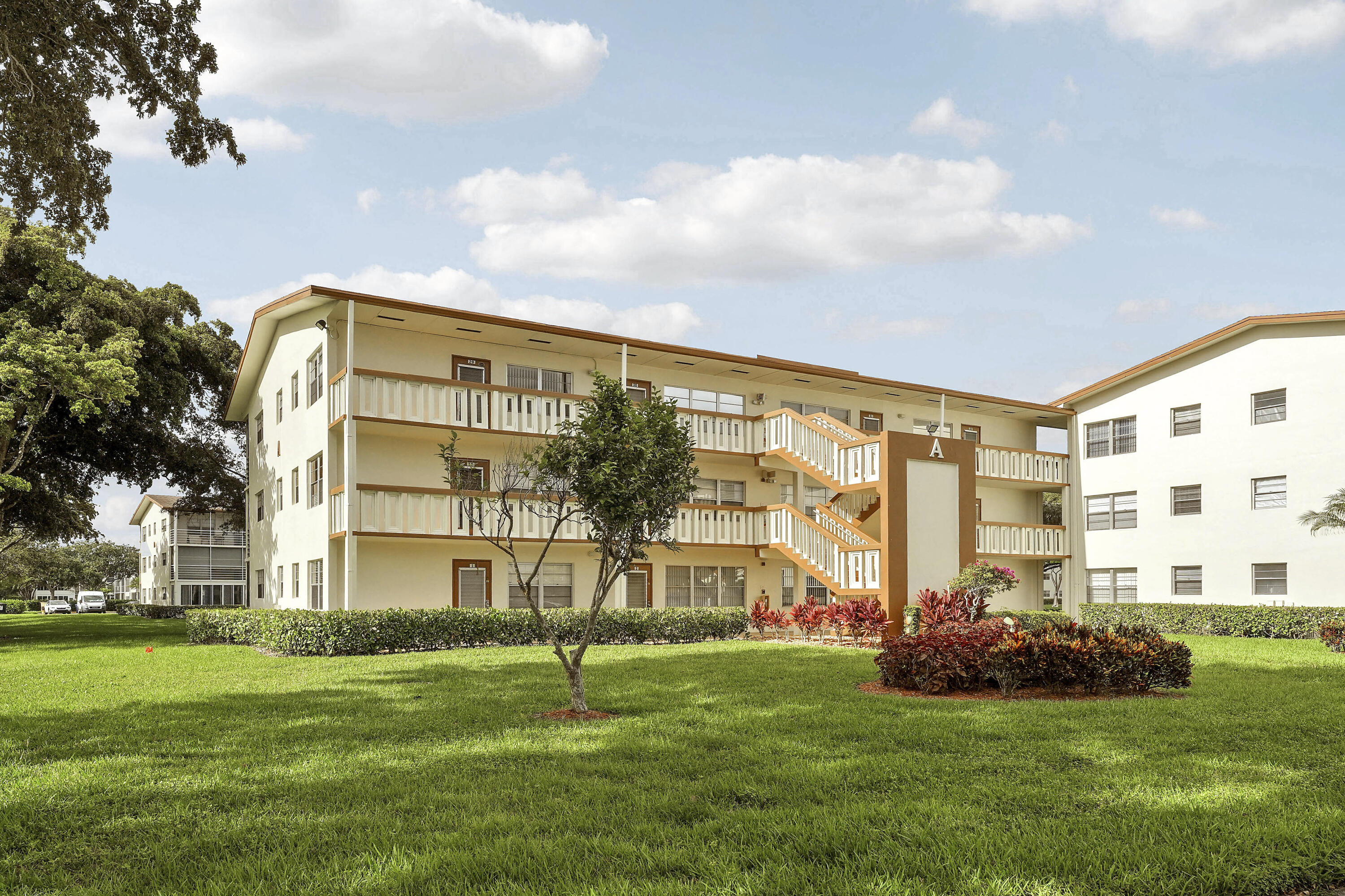 16 Mansfield B Boca Raton, FL 33434 - Photo 15 of 15 a view of a big building with a big yard and plants