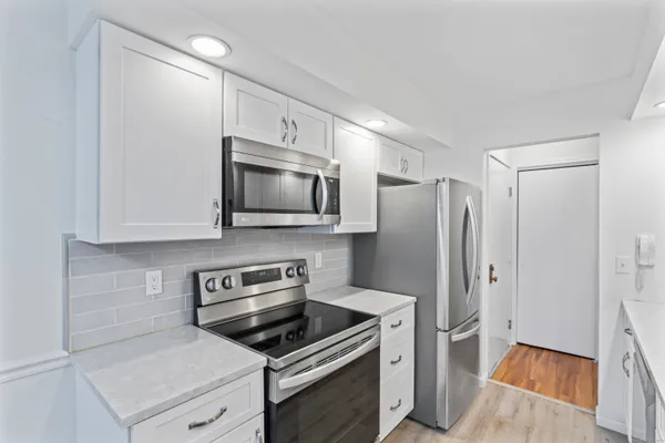 a kitchen with a stove microwave and refrigerator
