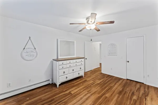 a view of a room with cabinet wooden floor and windows