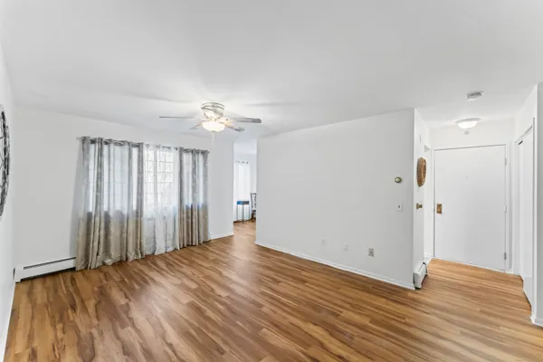 wooden floor in an empty room with a window