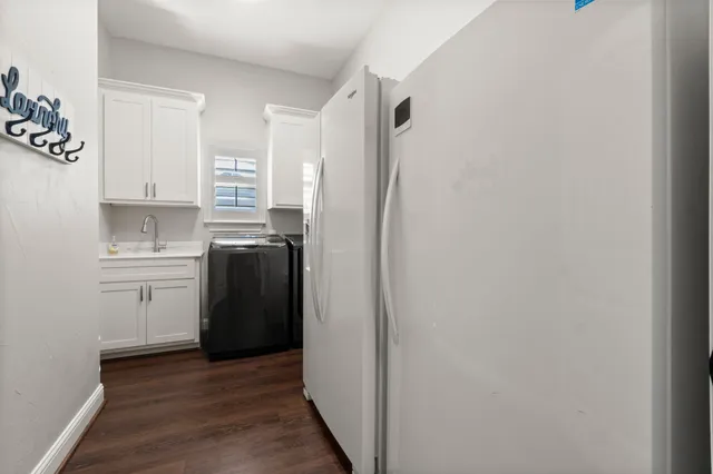a living room with furniture kitchen view and a chandelier