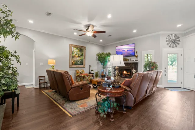a front view of a house with a yard and trees