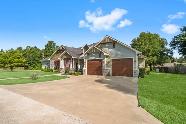 a front view of house with yard and green space