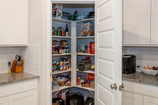 a kitchen with a refrigerator and a shelf