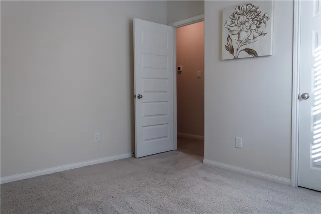 a bedroom with a bed and a night stand