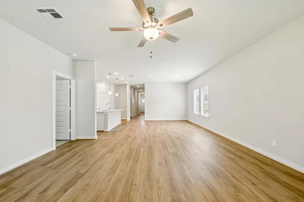 wooden floor in an empty room with a window