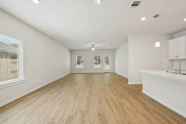 a view of a kitchen with wooden floor and a sink