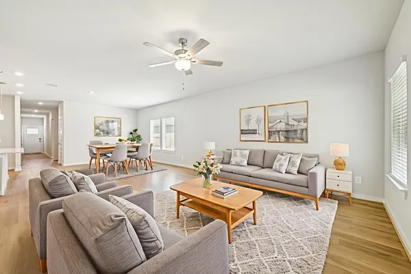 a living room with furniture and wooden floor