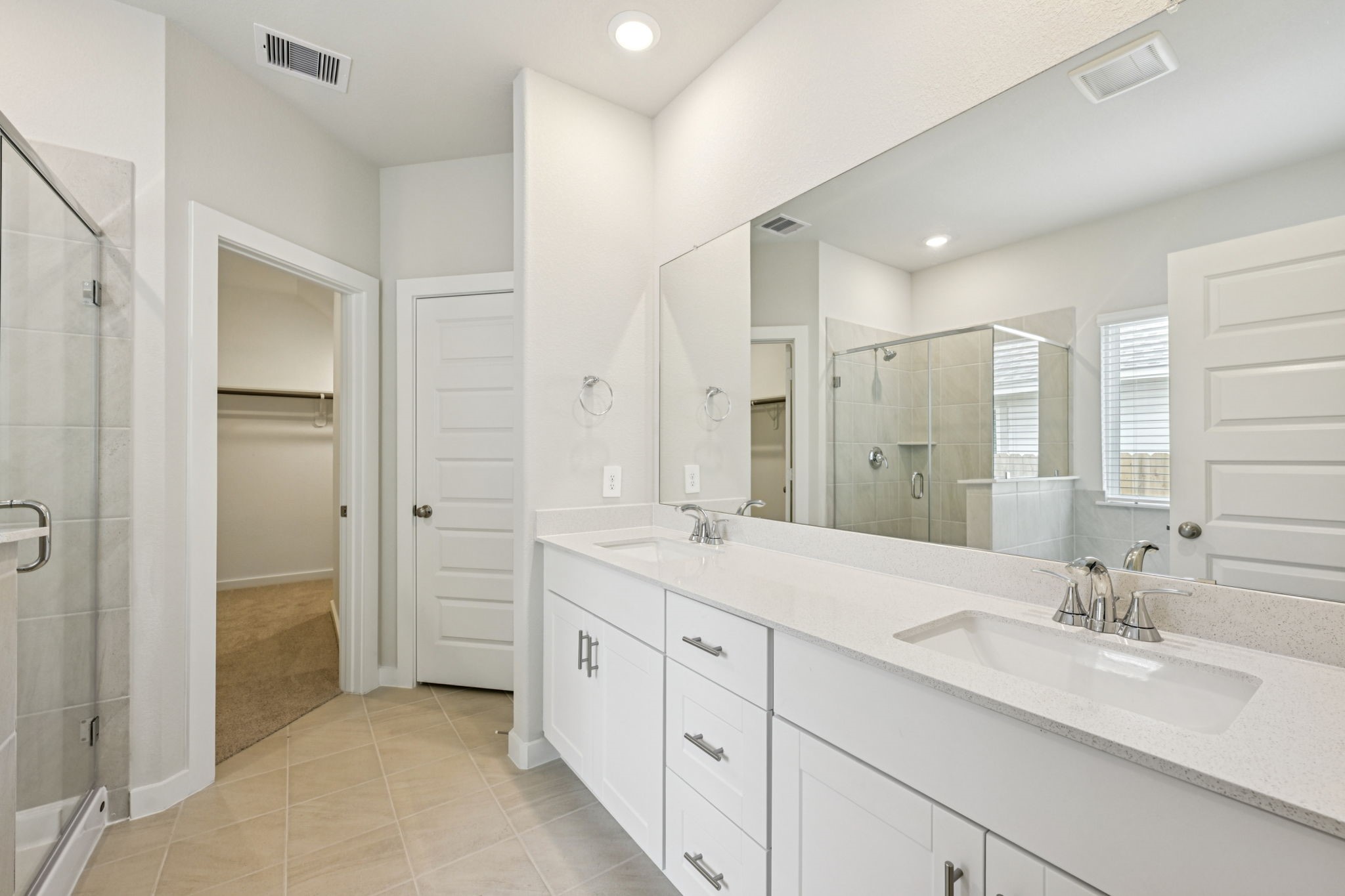 1653 Hopson Ranch Drive Conroe, TX 77301 - Photo 19 of 38 a spacious bathroom with a double vanity sink mirror and double