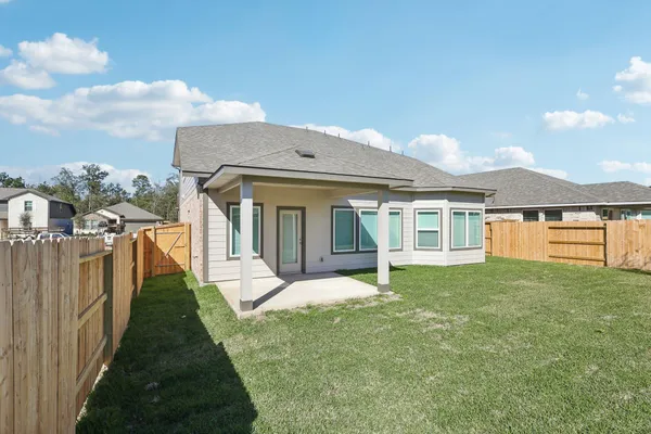 a view of a house with a yard and pathway