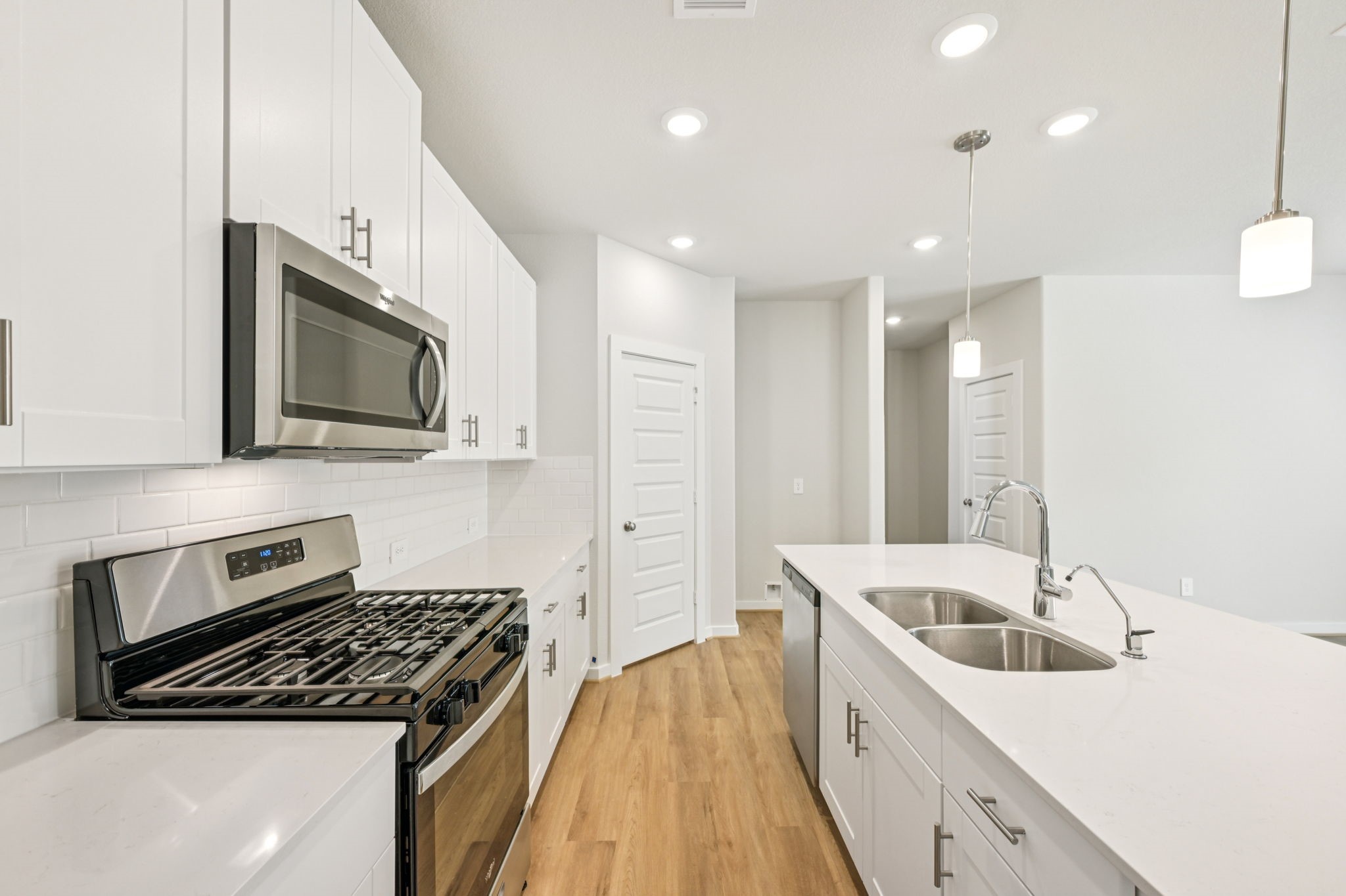 1653 Hopson Ranch Drive Conroe, TX 77301 - Photo 5 of 38 a kitchen that has a sink and a stove top oven
