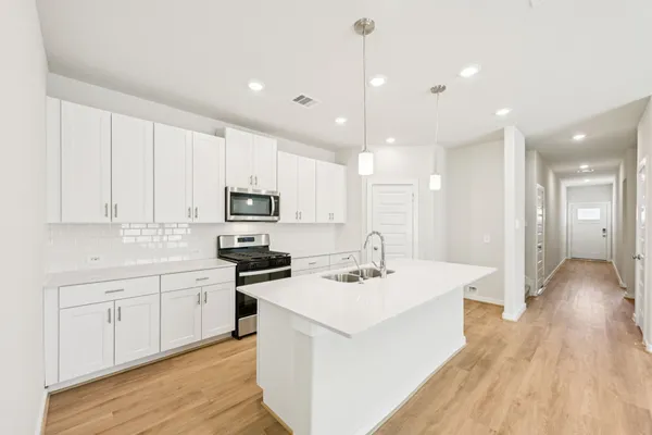a kitchen with stainless steel appliances kitchen island granite countertop a sink and cabinets