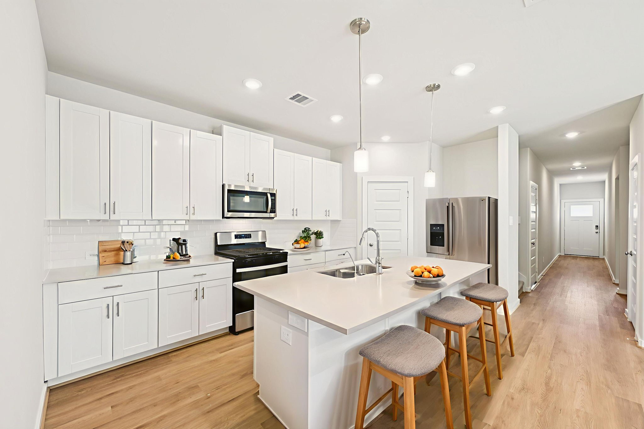 1653 Hopson Ranch Drive Conroe, TX 77301 - Photo 7 of 38 a kitchen with stainless steel appliances a stove a sink a refrigerator cabinets and a dining table